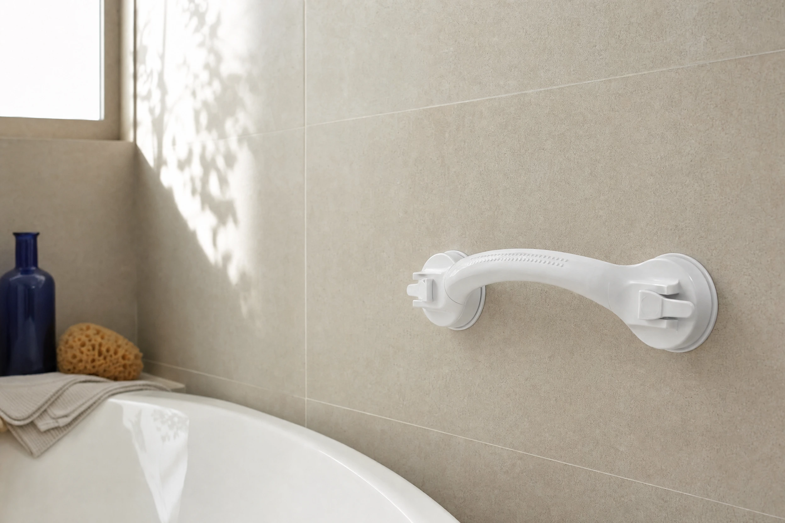 Illustrative suction-handle scene on a smooth bathroom surface